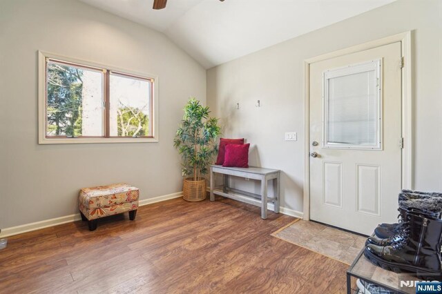 interior space featuring baseboards, lofted ceiling, wood finished floors, and ceiling fan