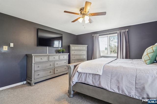 bedroom featuring a ceiling fan, baseboards, and light colored carpet