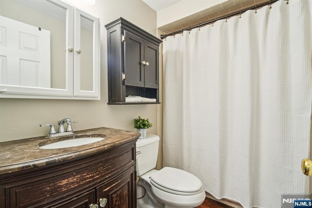 full bathroom featuring toilet and vanity