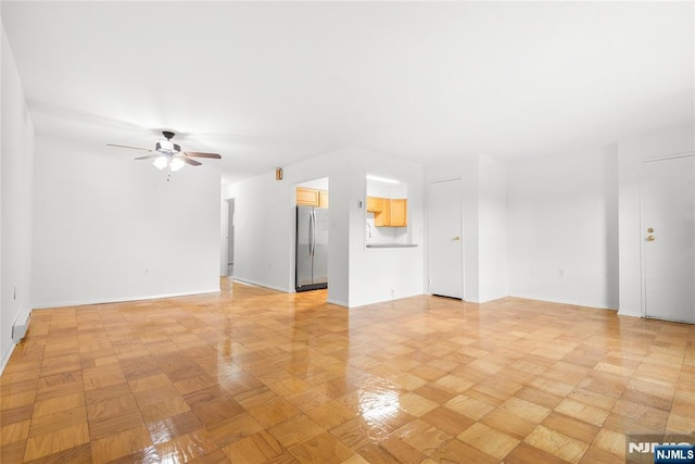 74 E Maple St, Teaneck, NJ 07666 - unfurnished living room with a ceiling fan and baseboards
