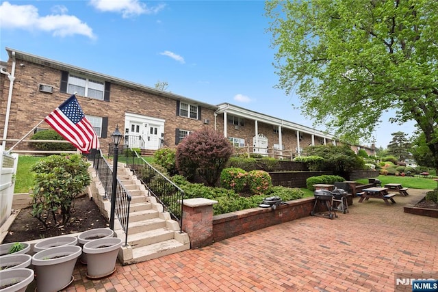 74 E Maple St, Teaneck, NJ 07666 - exterior space featuring stairway, brick siding, and a patio