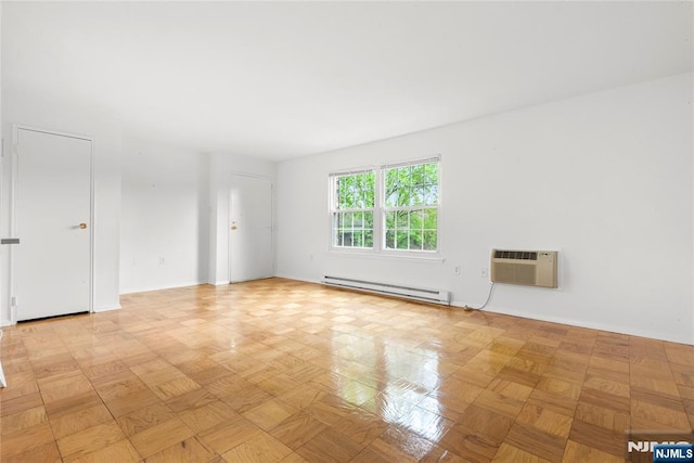 74 E Maple St, Teaneck, NJ 07666 - spare room with baseboard heating, a wall mounted AC, and baseboards