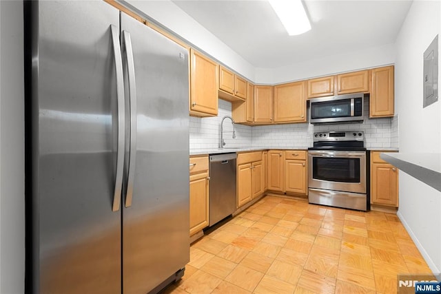 74 E Maple St, Teaneck, NJ 07666 - kitchen featuring stainless steel appliances, backsplash, a sink, and light brown cabinets
