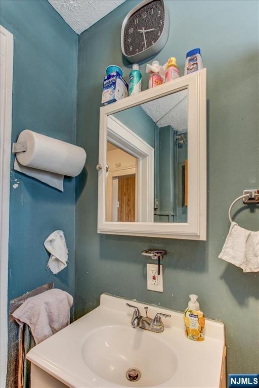 162 Summer St, Orange, NJ 07050 - bathroom featuring a textured ceiling and a sink