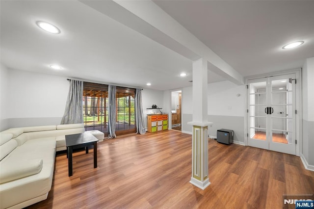 living area with recessed lighting, baseboards, and wood finished floors