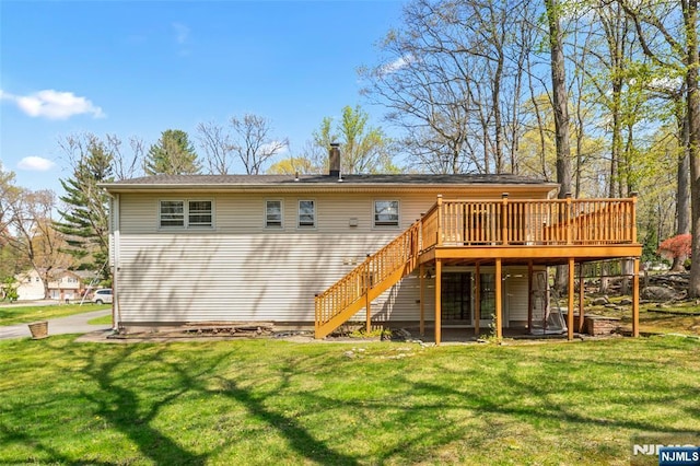 back of house featuring a wooden deck, a chimney, a yard, and stairway
