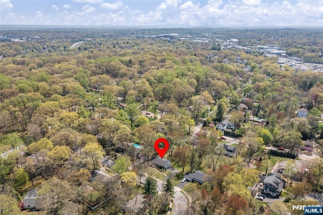 birds eye view of property featuring a view of trees