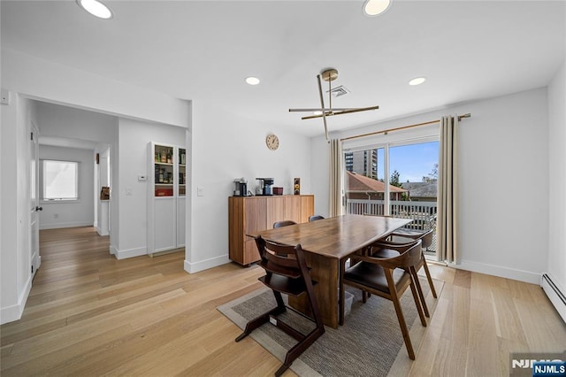 dining space with light wood-style floors, plenty of natural light, and recessed lighting