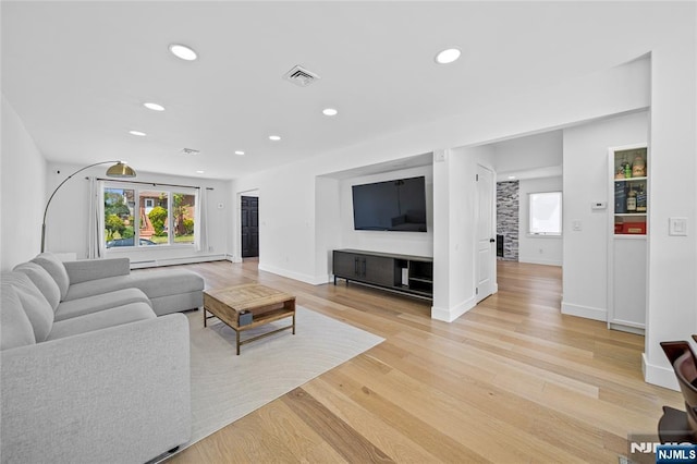 living room with light wood-style floors, baseboards, recessed lighting, and visible vents