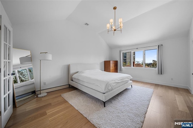bedroom featuring a notable chandelier, visible vents, vaulted ceiling, light wood-type flooring, and a baseboard heating unit