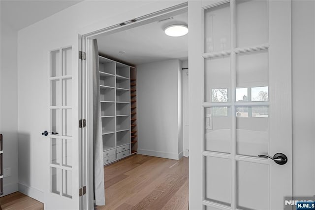 spacious closet with light wood finished floors
