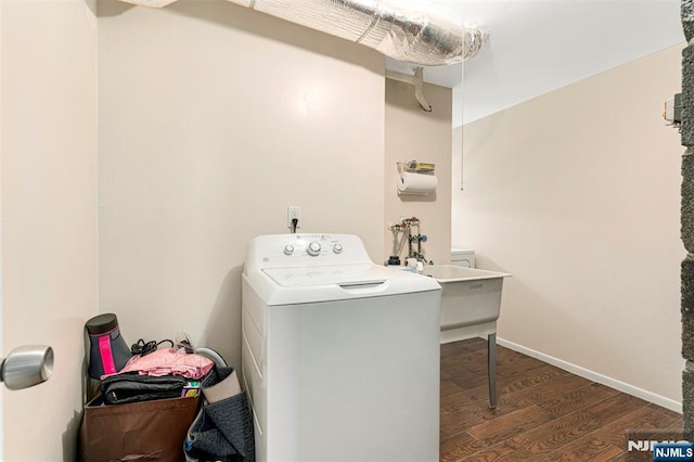 clothes washing area featuring dark wood-style flooring and washer / dryer