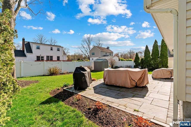 exterior space with a storage shed, a patio, a fenced backyard, and an outdoor structure