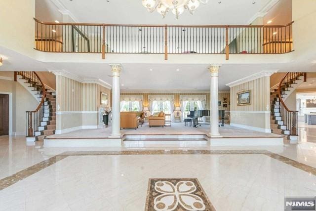 16 Shinnecock Trl, Franklin Lakes, NJ 07417 - entrance foyer with decorative columns, marble finish floor, baseboards, and stairs