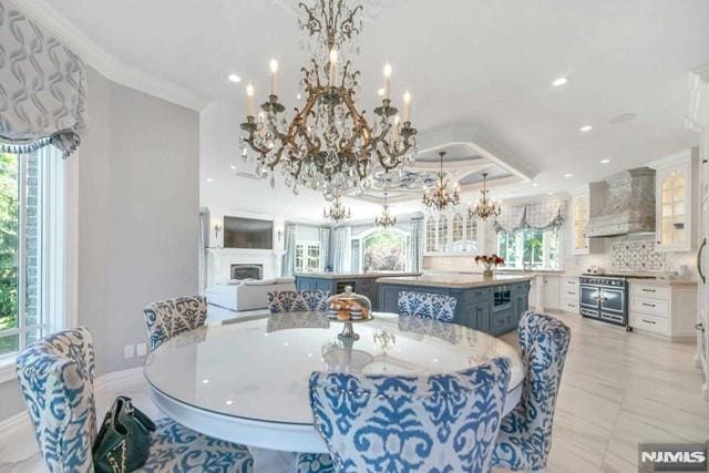 16 Shinnecock Trl, Franklin Lakes, NJ 07417 - dining space featuring recessed lighting, an inviting chandelier, ornamental molding, baseboards, and a fireplace