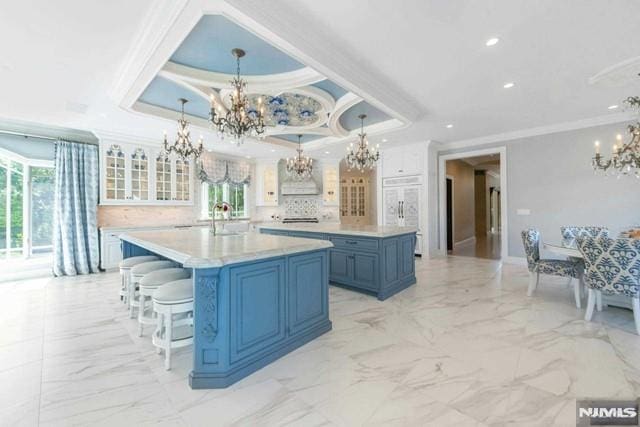 16 Shinnecock Trl, Franklin Lakes, NJ 07417 - kitchen with marble finish floor, crown molding, a spacious island, and an inviting chandelier