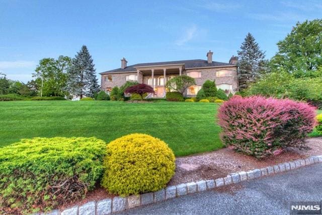 16 Shinnecock Trl, Franklin Lakes, NJ 07417 - single story home with stone siding, a chimney, and a front yard