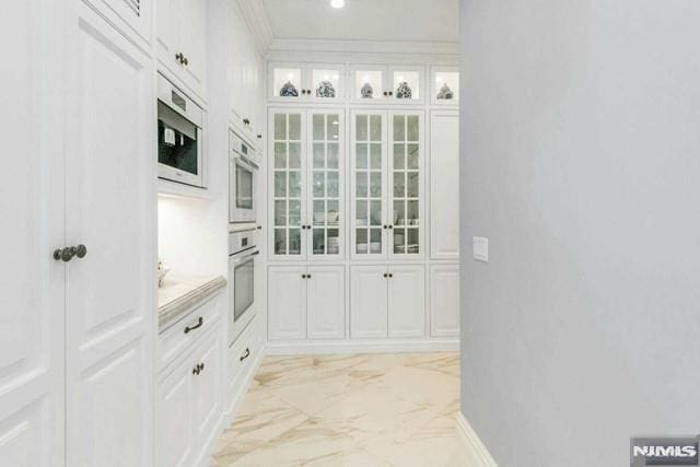 16 Shinnecock Trl, Franklin Lakes, NJ 07417 - kitchen featuring glass insert cabinets, marble finish floor, white cabinetry, and crown molding