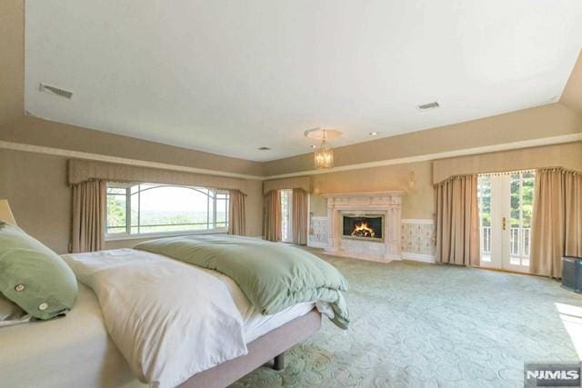 16 Shinnecock Trl, Franklin Lakes, NJ 07417 - bedroom featuring access to exterior, visible vents, a lit fireplace, and carpet floors