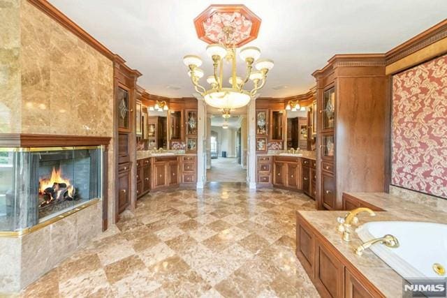 16 Shinnecock Trl, Franklin Lakes, NJ 07417 - bathroom with vanity, a garden tub, a chandelier, a high end fireplace, and ornamental molding