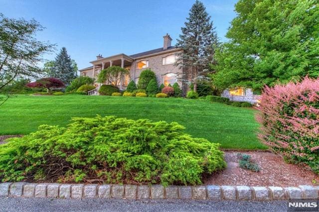 16 Shinnecock Trl, Franklin Lakes, NJ 07417 - view of front of house with a chimney and a front lawn