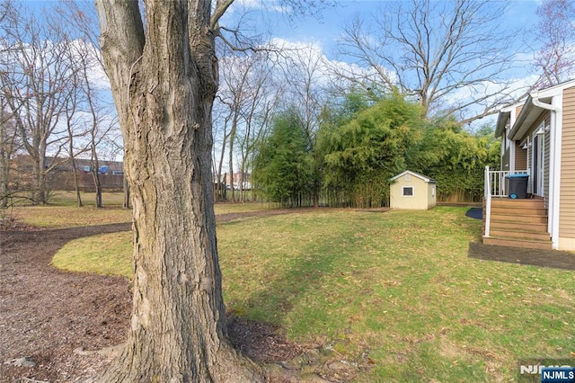 view of yard with a shed, an outdoor structure, and fence