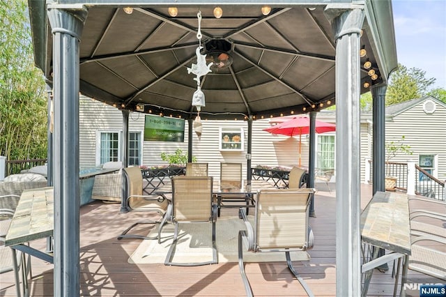 deck featuring a gazebo and outdoor dining area