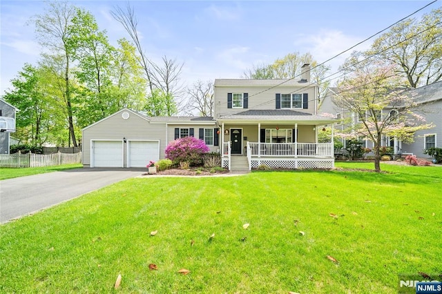 view of front of property with a garage, a front lawn, fence, covered porch, and driveway