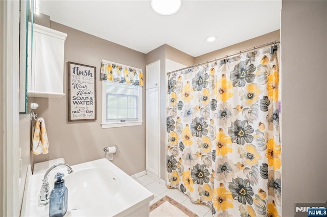 full bath with a sink, tile patterned flooring, and curtained shower