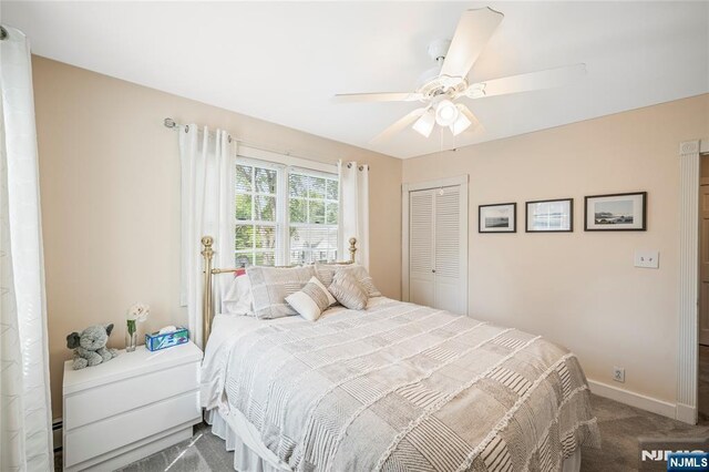 bedroom featuring baseboards, ceiling fan, carpet, and a closet