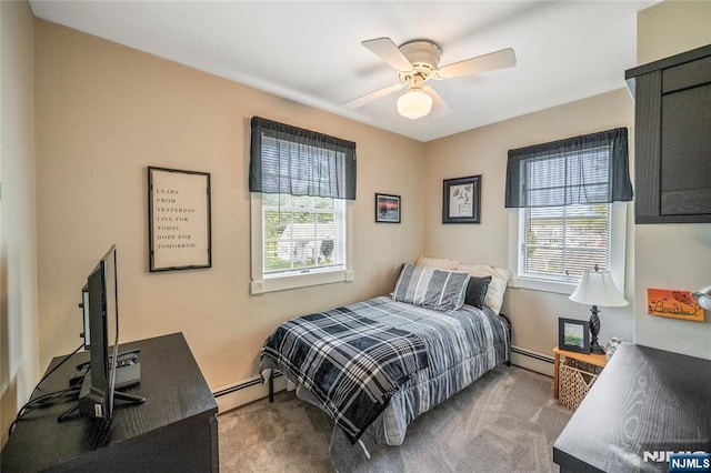 bedroom featuring a baseboard radiator, carpet floors, and multiple windows