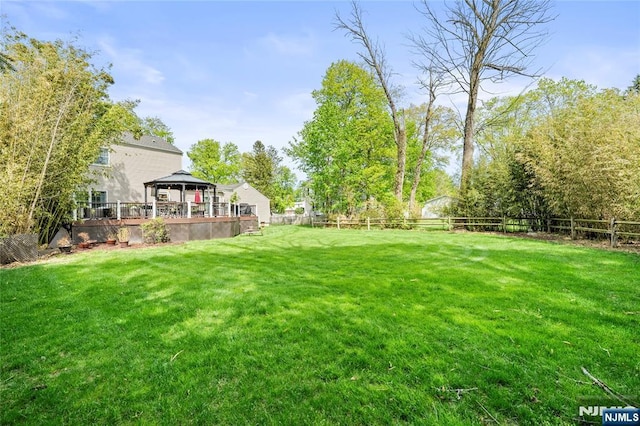 view of yard featuring a fenced backyard and a gazebo