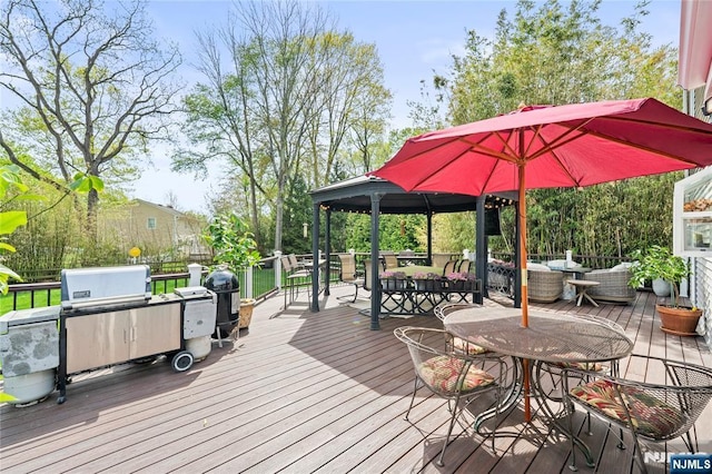 deck with a gazebo, outdoor lounge area, and outdoor dining space