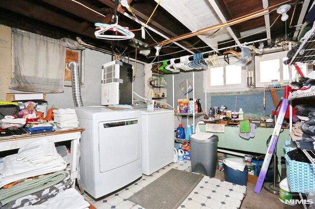 laundry area with washing machine and clothes dryer and laundry area