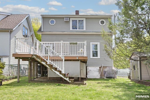 back of property with a chimney, a wooden deck, a yard, and stairs
