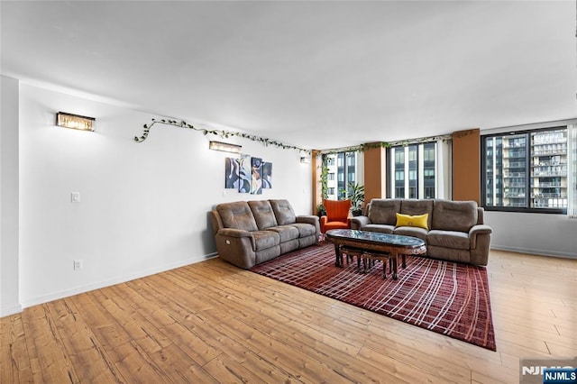 living room with baseboards and hardwood / wood-style flooring