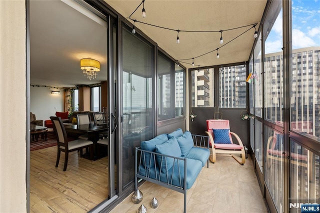 sunroom featuring rail lighting