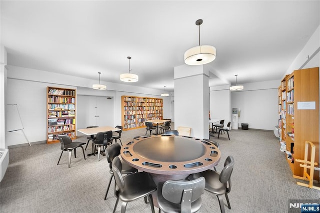 dining space featuring baseboards and carpet floors