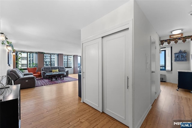 hall featuring light wood-style floors and radiator heating unit