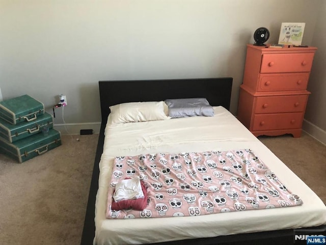 carpeted bedroom featuring baseboards