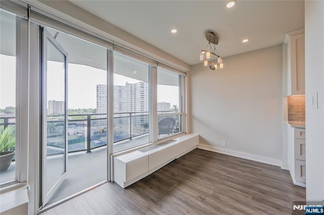 2077 Center Ave Unit 11C, Fort Lee, NJ 07024 - unfurnished dining area with plenty of natural light, dark wood-style floors, recessed lighting, a view of city, and baseboards