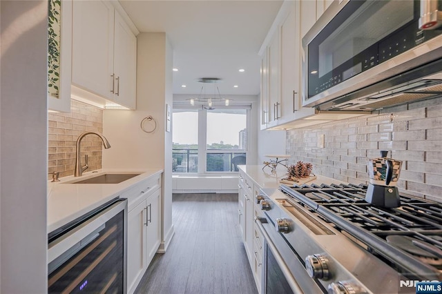 2077 Center Ave Unit 11C, Fort Lee, NJ 07024 - kitchen featuring stainless steel appliances, wine cooler, a sink, white cabinetry, and recessed lighting