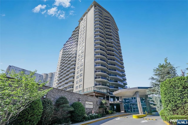2077 Center Ave Unit 11C, Fort Lee, NJ 07024 - view of building exterior featuring uncovered parking
