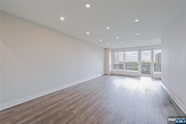 2077 Center Ave Unit 11C, Fort Lee, NJ 07024 - spare room featuring recessed lighting, wood finished floors, and baseboards