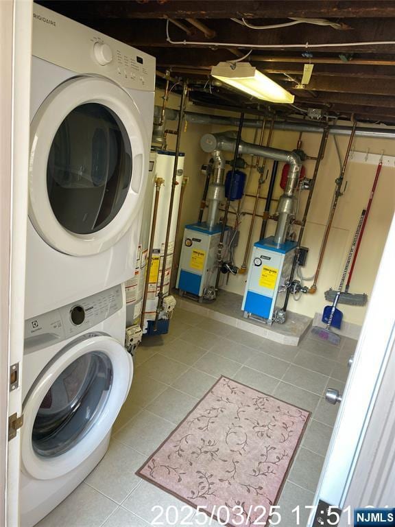 laundry room featuring a heating unit, stacked washer and clothes dryer, laundry area, tile patterned floors, and water heater