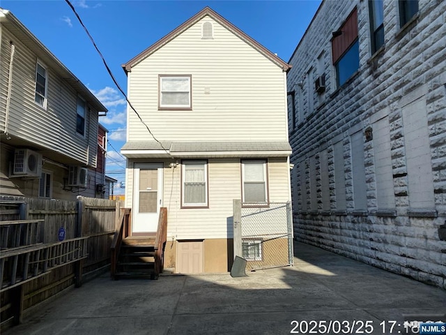 back of house featuring fence and entry steps
