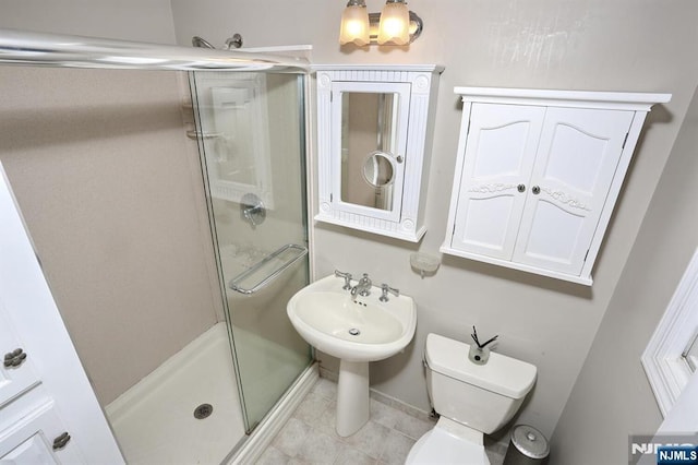 full bathroom with a stall shower, toilet, and tile patterned flooring