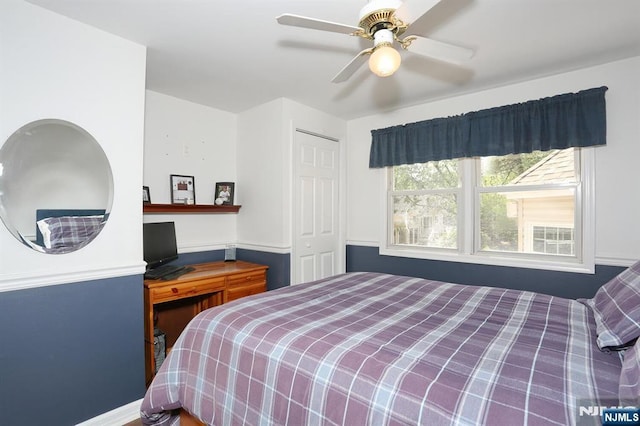 bedroom with a ceiling fan, baseboards, and a closet
