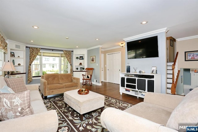 living area featuring ornamental molding, stairs, built in features, wood finished floors, and baseboards