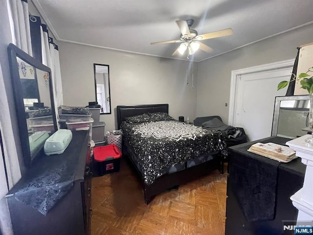 bedroom featuring ceiling fan and ornamental molding